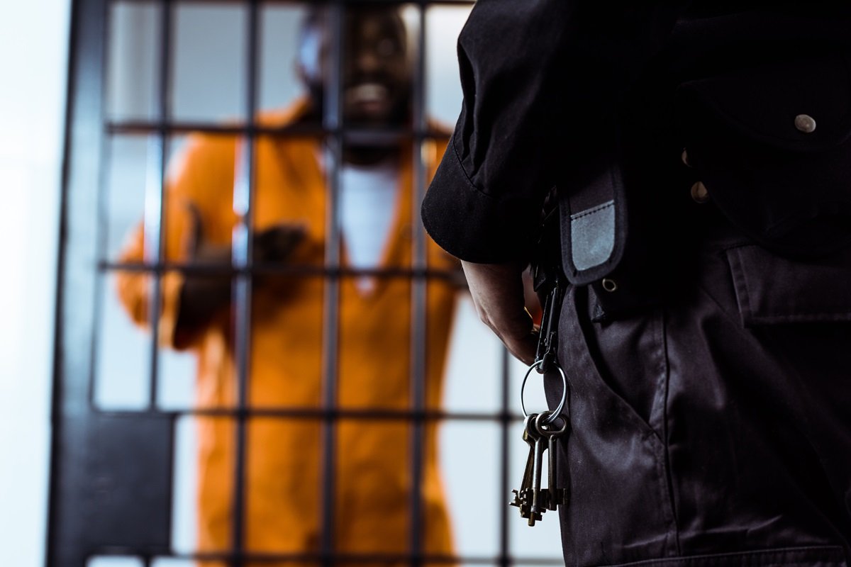 A close-up of a woman holding a gun